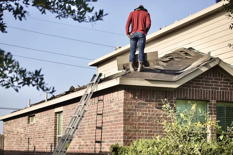 Professional roofer working on a residential roof in Fullersburg